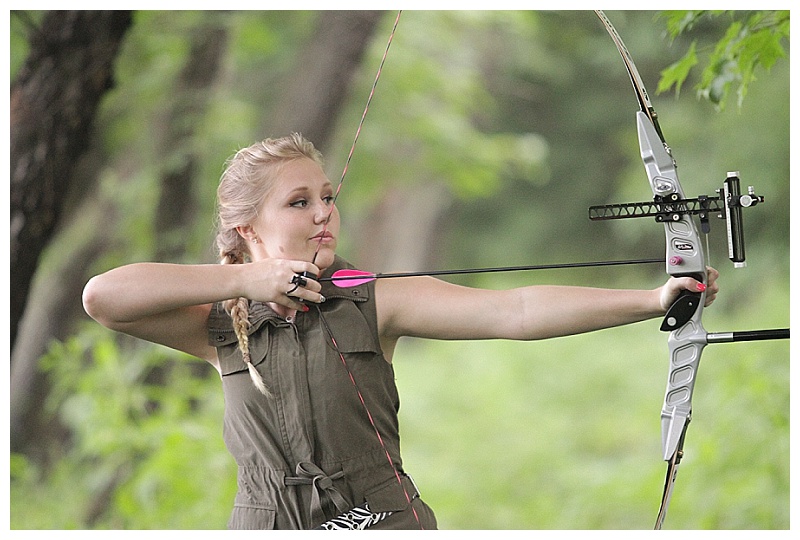 girl shooting archery senior portraits