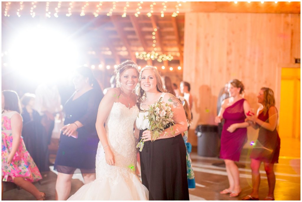 wedding reception bouquet toss in barn