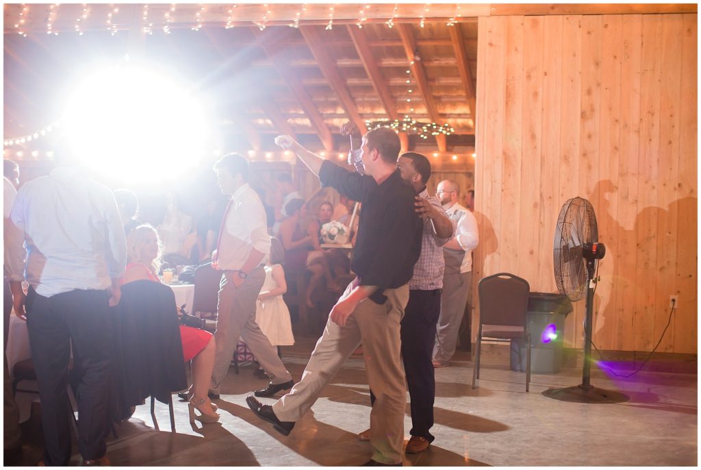 wedding reception garter toss in barn